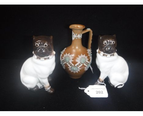 A PAIR OF CERAMIC PUG ORNAMENTS and a small vase