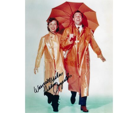 Actor, Debbie Reynolds signed 10x8 Singin' In The Rain colour photograph pictured during her breakout role was her first lead