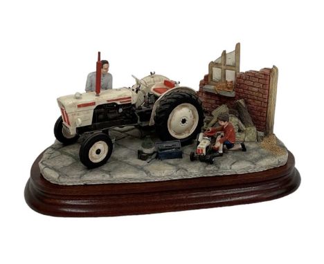 BORDER FINE ARTS; a model tractor, 'Like Father Like Son', height 13cm, on wooden base. Boxed.