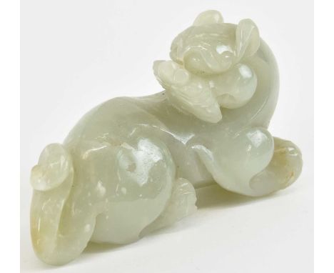 A Chinese carved green jade figure of a recumbent tiger, height 5.5cm, length 9cm.