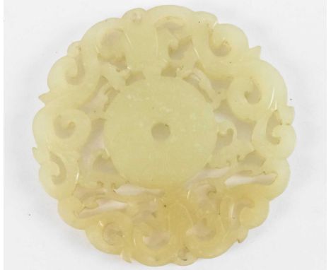 A Chinese carved jade bi disc, decorated with scrolling foliage, diameter 5cm.