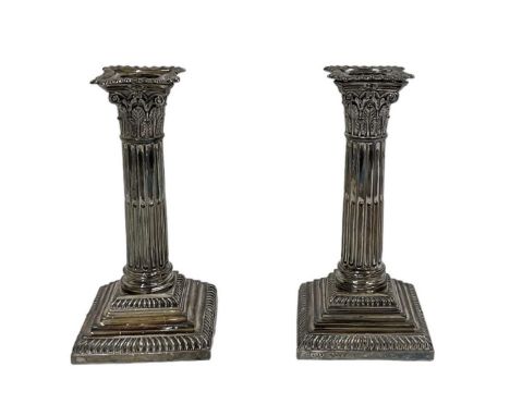 JOHN KIRSTEN BAILY; a pair of Victorian hallmarked silver candlesticks, loaded, Sheffield 1889, height 17.5cm.