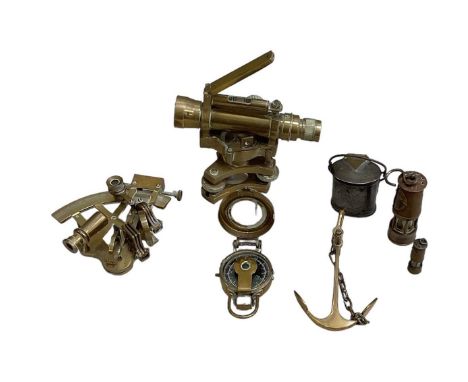 A reproduction brass sextant, a reproduction brass dumpy level, compass, brass anchor, two miniature miner's lamps and a pewt