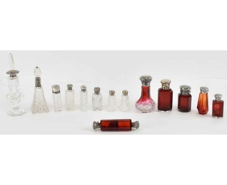 A collection of 19th century and later cut and cranberry glass hallmarked silver topped perfume bottles, including cranberry 