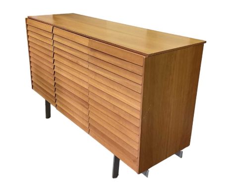 PUNT MOBLES; a mid century light oak veneered sideboard with three drawers above three cupboard drawers, raised on chrome sup