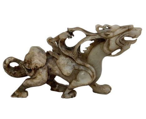 A Chinese carved white hardstone model of a dragon (possibly jade), height 20cm, length 37cm.