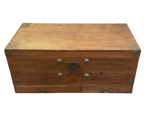 A Sri Lankan teak brass bound trunk, with swing loop carrying handles (one af), width 122cm, depth 51cm, height 57cm.