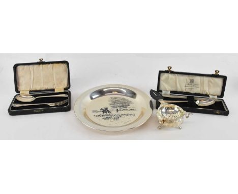 A cased George V hallmarked silver spoon and matching fork, Birmingham 1945, a cased hallmarked silver spoon, a white metal t