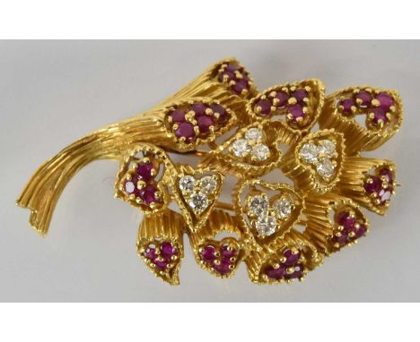 A fine yellow metal ruby and diamond brooch modelled as a floral spray, with ten groups of rubies and four groups of round br