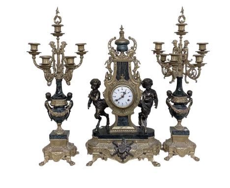 A modern gilt metal mounted and marble mantel clock, flaked by pair of cherubs, the white painted dial set with Roman numeral