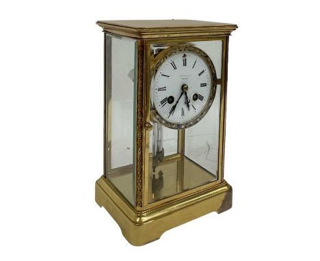A French brass and enamel cased clock with four glass panels, the white enamel dial set with Roman numerals (af), height 25cm