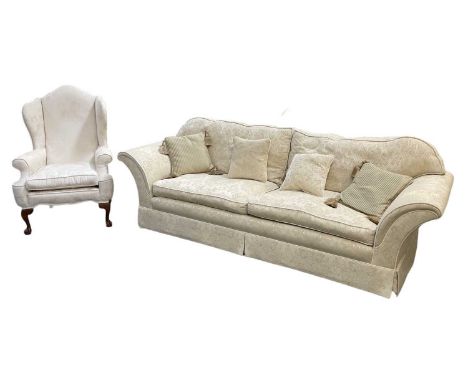 PETER GUILD FOR HARRODS; a cream floral upholstered three seater settee, width 255cm, and matching floral upholstered wingbac