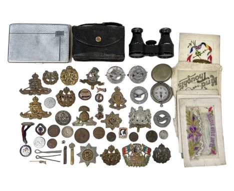 A quantity of military badges, buttons and cap badges, cigarette cards, compass, pocket binoculars and a chrome painted cigar