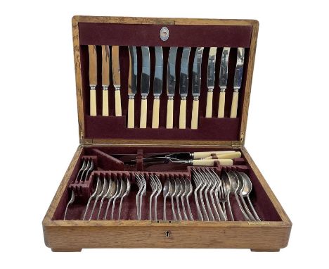 HARRODS; an early 20th century oak cased silver plated canteen of cutlery, with ivorine handles.