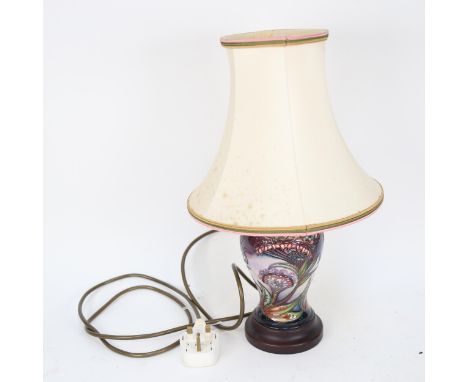 A Moorcroft table lamp and shade, with tube-lined stylised floral decoration 
