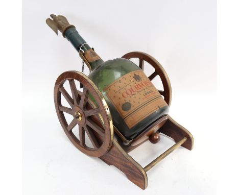 A table cannon, containing an empty bottle of Courvoisier Cognac with eagle stopper, length 56cm overall 