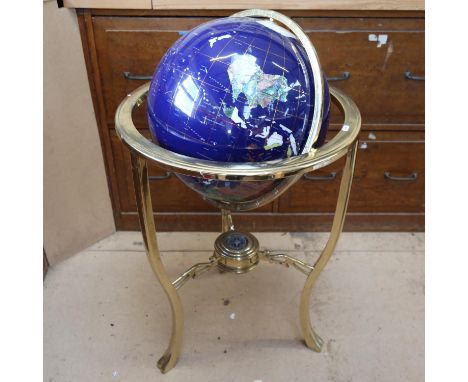 A large reproduction floor standing hardstone terrestrial globe, in brass gimballed mount, with compass inset base, globe dia