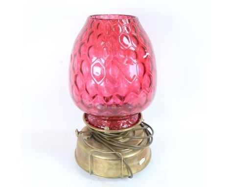 A large early 20th century Sherwoods Sun brass oil lamp, converted to electric, with large honeycomb cranberry glass shade an