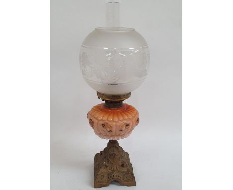 A Victorian oil lamp, on pierced cast-iron plinth, with peach glass font and etched glass shade, and chimney, 51cm