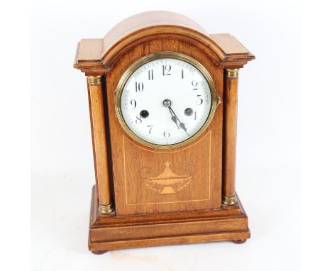 An early 20th century light oak-cased 8-day dome-top mantel clock, architectural design with satinwood inlay, white enamel di