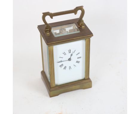 A brass-cased carriage clock, white enamel dial with Roman numeral hour markers and glass exhibition plates, case height 12cm
