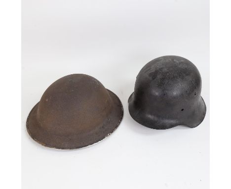 A Second World War Period British Army Brodie steel helmet, and a German Army Stahlhelm helmet (2) 