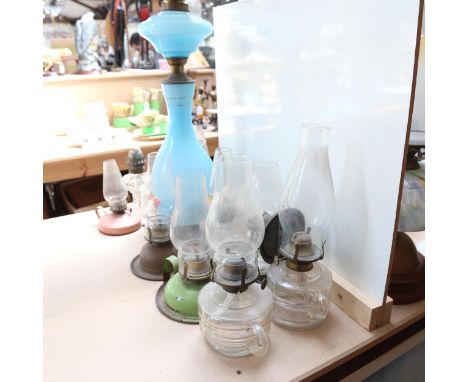 A Victorian blue glass oil lamp with Napoleon print, height 80cm, and 10 small oil lamps 