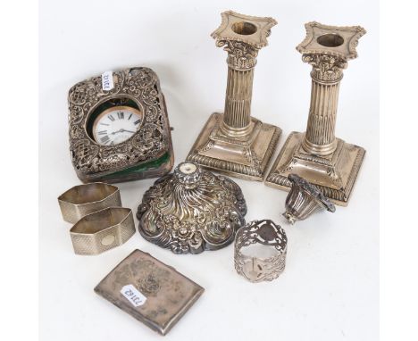 A group of silver items, to include a pair of silver-clad Corinthian column candlesticks, an embossed single silver candlesti