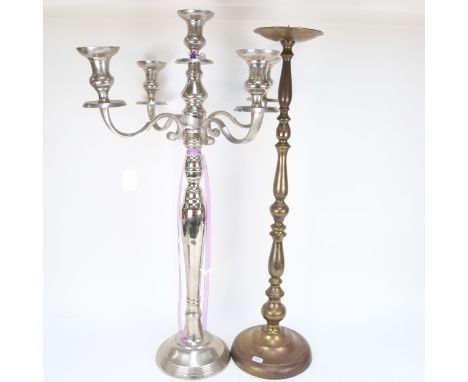 A turned brass pricket candlestick, 74cm, and a polished metal candelabrum 