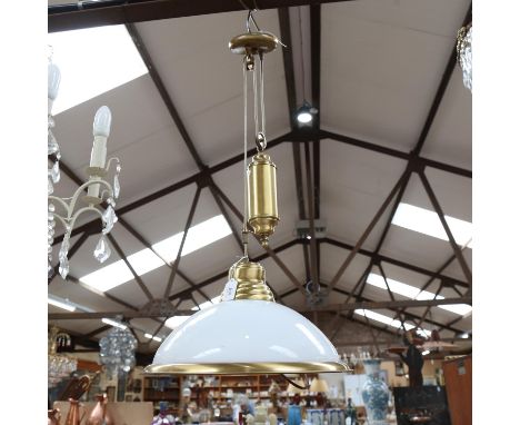 A brass-framed rise and fall ceiling light fitting, with milk glass shade, shade diameter 41cm 