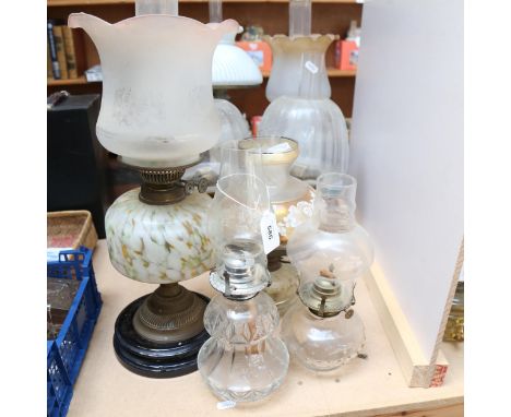 A group of oil lamps, including a pair of Masons Ironstone, a Victorian milk glass oil lamp with shade and chimney, height 56