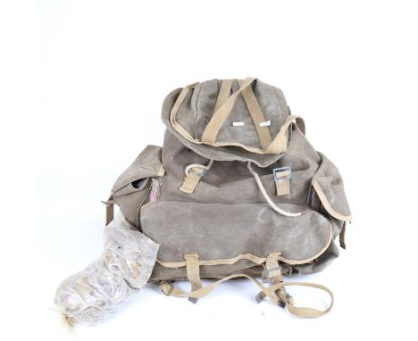 A Vintage Norwegian Army telemark canvas rucksack, containing an American Army rolled canvas tent covering and ropes 