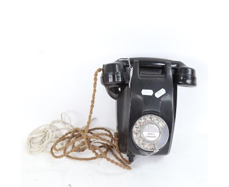 A Vintage black wall-hanging dial telephone, converted to modern 