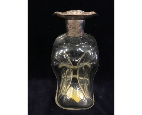 A pinched glass decanter with silver collar.