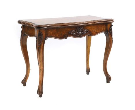 A Continental walnut card table, 19th Century, the foldover top above carved frieze on cabriole supports 92cm wide 45cm wide 