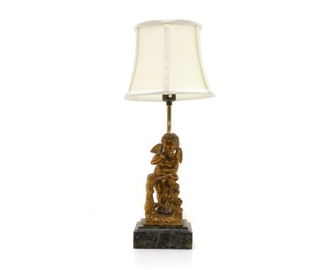 A gilt bronze table lamp, 20th century, modelled as a cherub, raised on a marble plinth, with a plain shade, 50cm highConditi