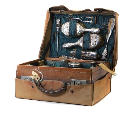 A Victorian pigskin leather vanity case,  complete with a fitted interior, to include silver mounted jars, brushes and a comb