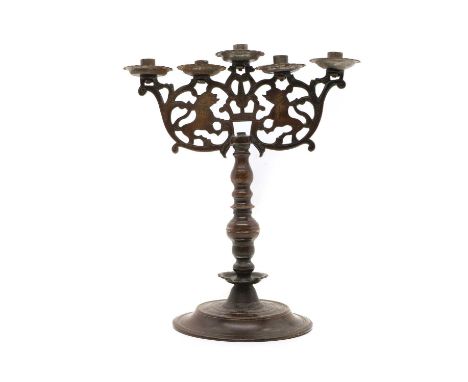 A bronze Shabbat candelabra 18th century, probably Polish, with five sconces above a pierced frame with stylised animals and 