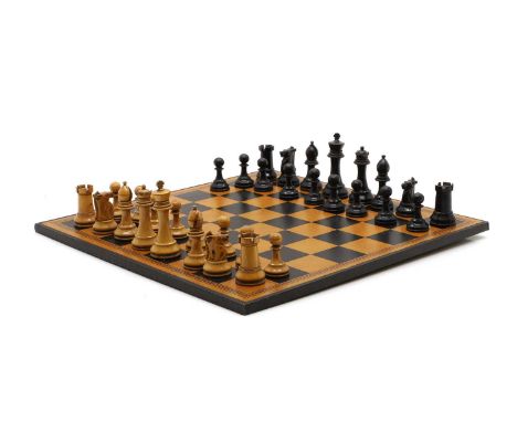 A Staunton pattern chess set, 20th century, plain and ebonised, king 9.5cmqueen 8cm highpawn 5cm, with a modern board, inscri