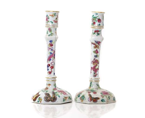 A pair of Chinese porcelain candlesticks,  19th century, the square collumn raised on an octagonal base, decorated with flora