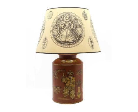 A Toleware lamp  20th century, of cylindrical form, depicting a man in an abstract landscape painted in a gold tone against a