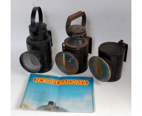 An LMS austerity 3 aspect hand lamp with reservoir and burner, a similar BR lamp and a part lamp (case only) with bullseye le