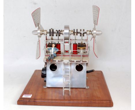 An unusual home made polished metal stationary hot air engine comprising of polished metal A frame base, supporting two steam