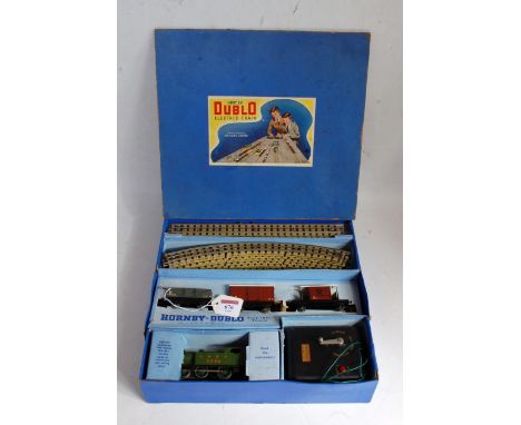 A Hornby Dublo 3-rail tank goods set containing post war LNER green 0-6-2 tank engine, 3 wagons, track oval, controller (all 