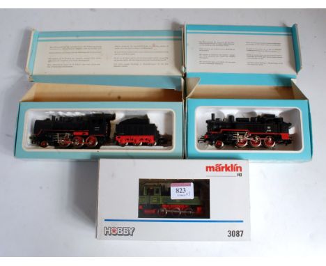 A Marklin H0 DB black class 34 2-6-0 engine and tender in blue box (G-BG), a class 74 2-6-0 tank engine also in blue picture 