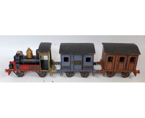 A late 19th century wooden and cast metal German carpet train comprising of black, red and green hand painted 0-4-0 locomotiv