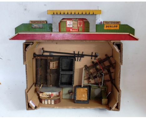 Small tray of wooden accessories including bookstall, 5x buffers, 2x telegraph poles, metal water arm, water pump (all a/f), 