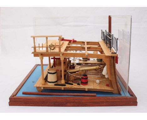 A wooden scale cross section model of the interior on the gun deck of a ship, displayed in a perspex case. 36 x 34cm.