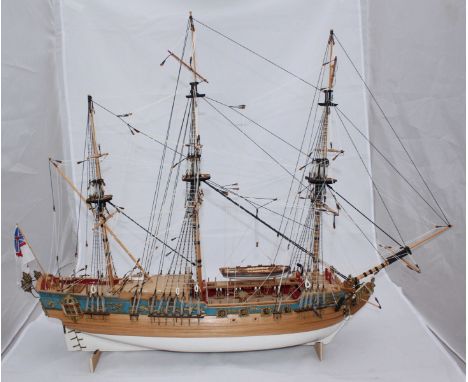 A wooden scale model of a fully rigged, three-masted frigate, with planked hull, 80cm long.