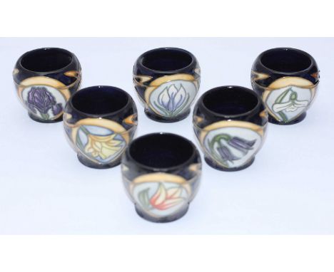A set of Six Moorcroft Egg Cups painted with flowers in the 'Parisian Dream' pattern after Sian Leeper, copyright 2004, 'Octa